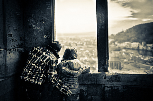 kids looking over city in abandonded building