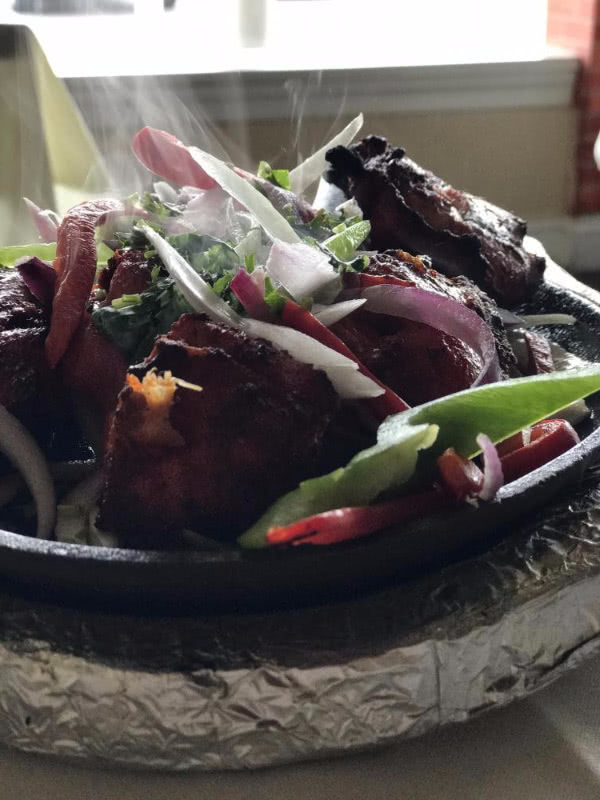 steaming tandoori chicken and vegetables close-up